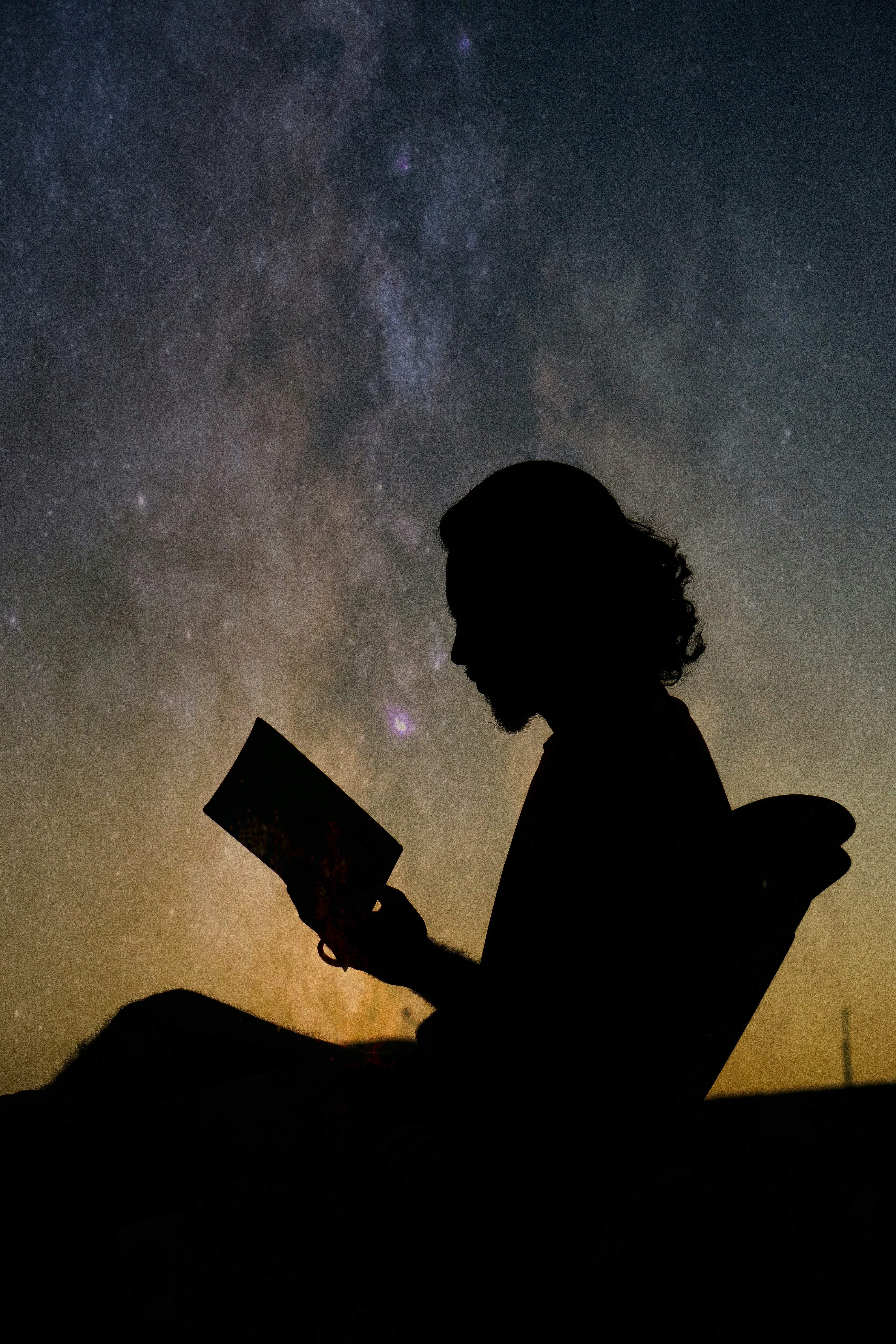 Woman reading under the stars